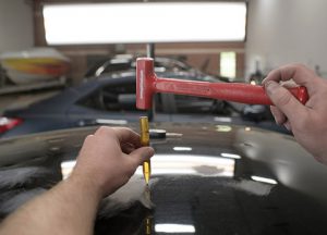 Preforming auto dent repair in Denton TX