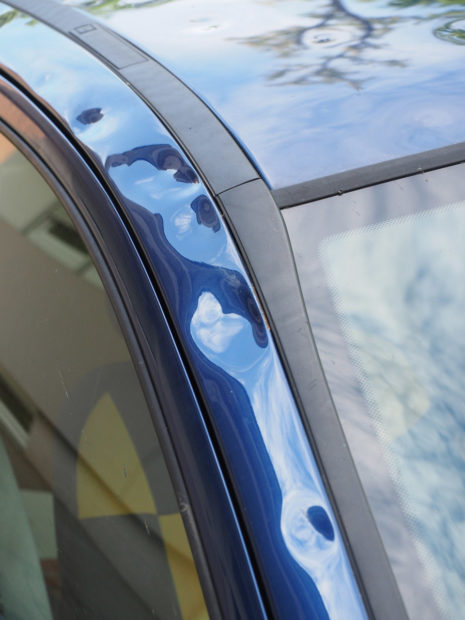 Close up of hail damage on car