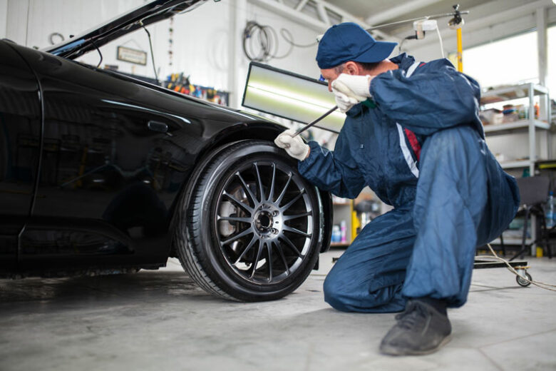 Body Shop doing wheel service for a Highland Village, TX, car