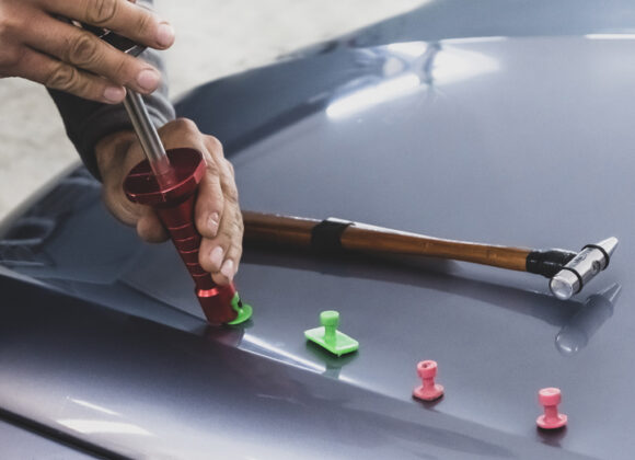 a technician using tools to perform Dent Repair in Dallas, Fort Worth, Little Elm, Flower Mound, North Dallas, Roanoke, TX